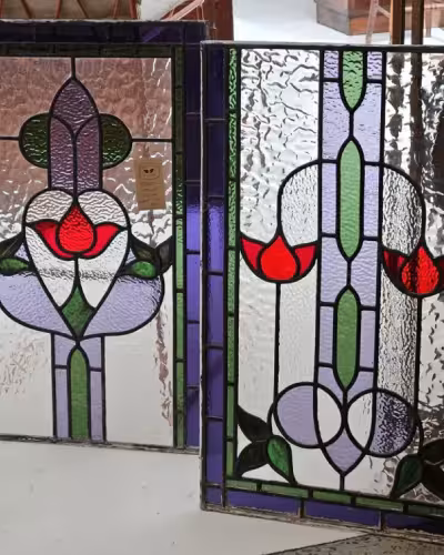 Glazier restoring stained leaded glass panel